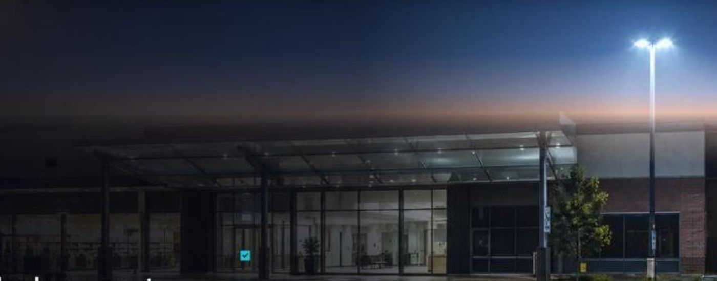 Shopping centre entrance at dawn after an overnight maintenance handover (illustrative)